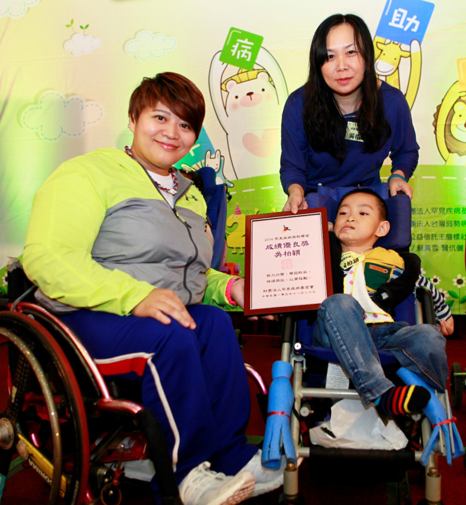 萊希尼亨症候群病友吳柏穎榮獲成績優良獎學金，由里約帕奧健力銅牌林資惠(左)頒獎給他。圖／罕病基金會提供