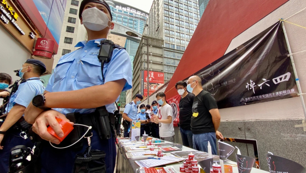 香港支聯會堅持悼念六四，大批軍裝警員搜查支聯會母親節街站。圖／擷自美國之音湯惠芸