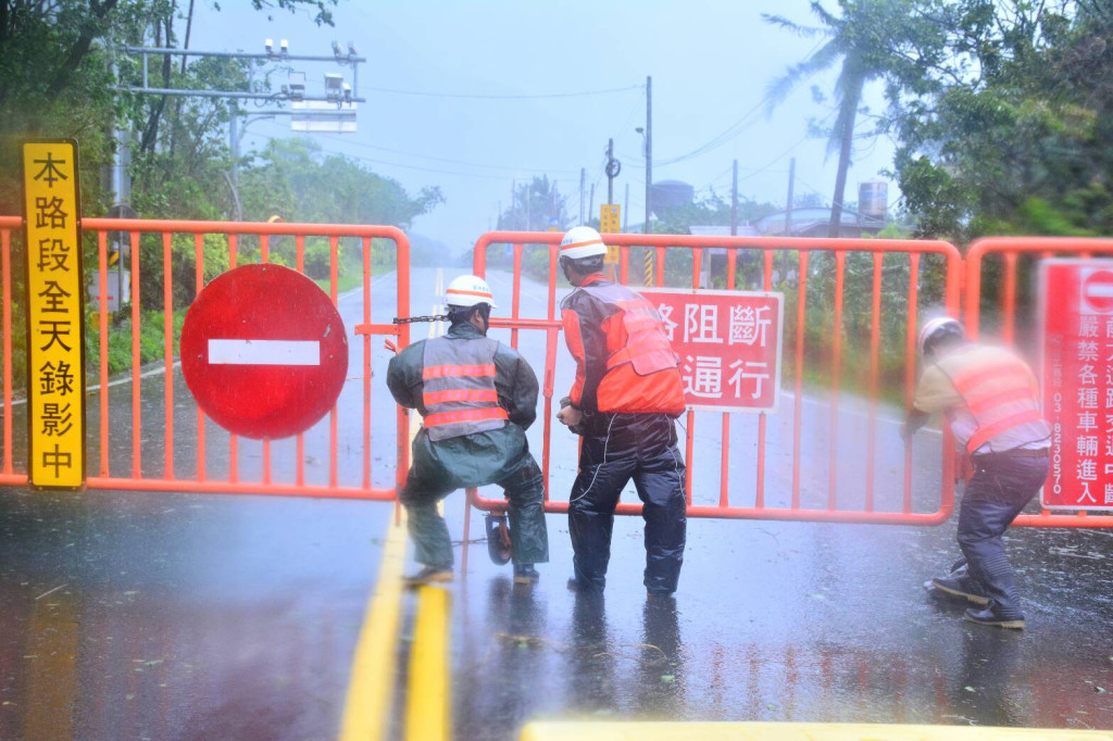 蘇花封閉，公路局人員使盡力才將鐵門拉上，可見當時風雨之大。（王志偉攝）