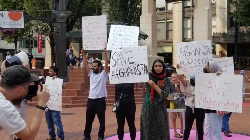 在 Portland 法院前的廣場上,遇到了一些阿富汗的移民們舉著牌子在呼籲美國人士幫助阿富汗的難民。圖／陳東榮